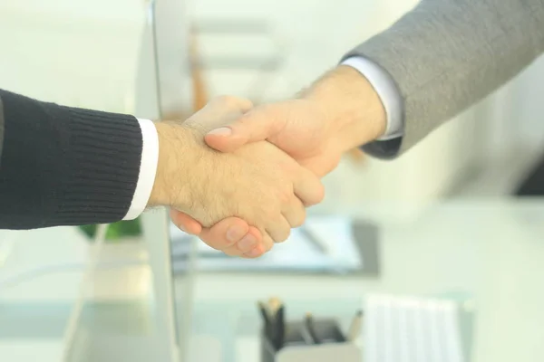 Primer plano .los socios financieros estrechando las manos sobre un escritorio — Foto de Stock