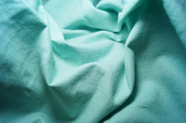 Crumpled blue fabric cotton macro vignetting canvas — Stock Photo, Image