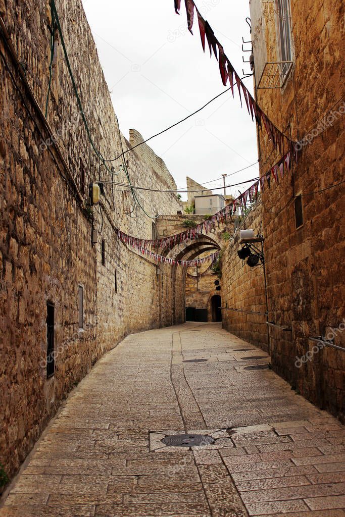  Narrow cobbled street in the Jewish quarter in the old historical part of Jerusalem, Israel.