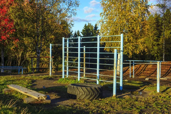 Retro sports field with horizontal bar, parallel bars and sports wall