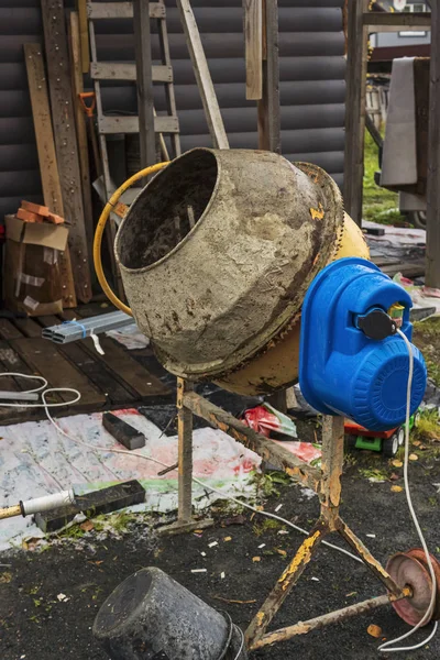 Mobile concrete mixer at a construction site, vertical image