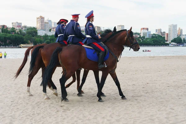 Rostov-on-Don / Russia - 17 June 2018: Don Cossacks in blue uniform riding on a brown horse are on duty during football matches