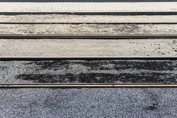 New tram tracks during the reconstruction of the street are flooded with liquid asphalt in the center of a large city