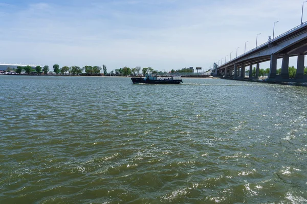 stock image Rostov-on-Don / Russia - May 2018: A small blue boat with an internal combustion engine leisurely swims along the shore along the Don river on a warm, sunny day