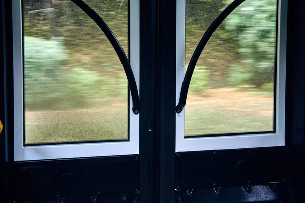 glass doors with metal handrails on the new bus while driving at high speed view from the interior