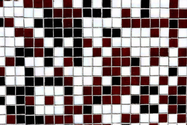 close-up view of black, white and maroon decorative tiles background 