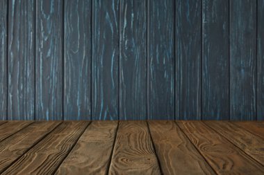 brown striped tabletop and dark blue wooden wall clipart