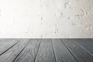 gri ahşap masa üstü ve beyaz duvar tuğla ile
