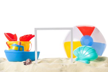 Beach toys and frame in sand isolated on white clipart