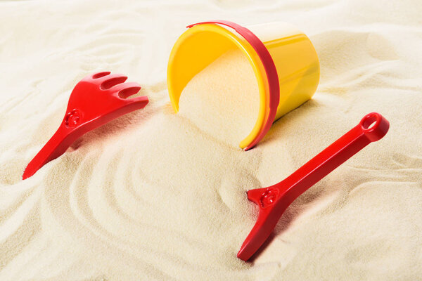 Kids toys and bucket on sandy beach