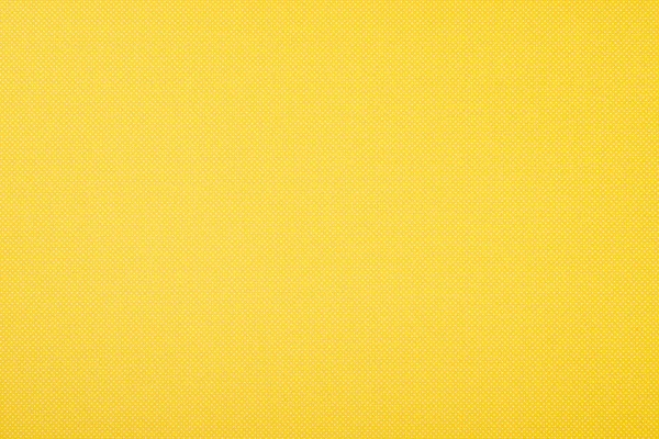 Texture of polka dot pattern on yellow background