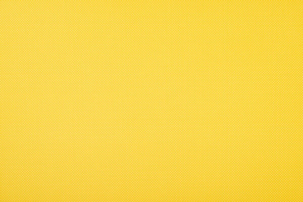 Texture of polka dot pattern on yellow background