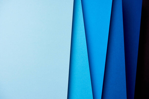 Abstract background with paper sheets in blue tones