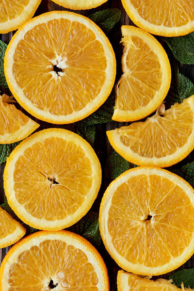 top view of fresh orange slices and mint leaves, organic background 