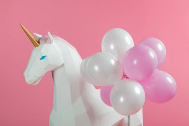 Party decoration with unicorn and balloons isolated on pink clipart