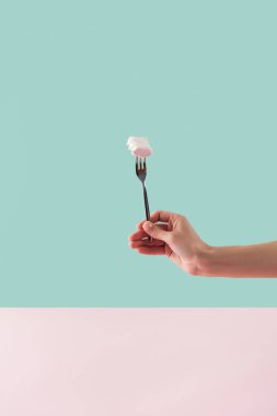 cropped view of tattooed hand with sweet marshmallow on fork clipart