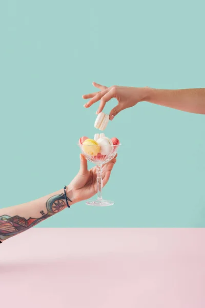 Cropped View Woman Taking Macaron Glass Bowl Tattooed Hand — Stock Photo, Image