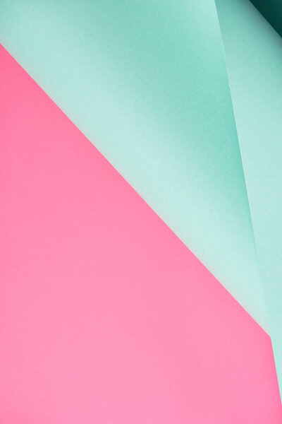 close-up view of bright turquoise and pink colored paper background   