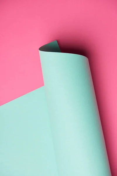 Close View Rolled Turquoise Paper Pink Background — Stock Photo, Image