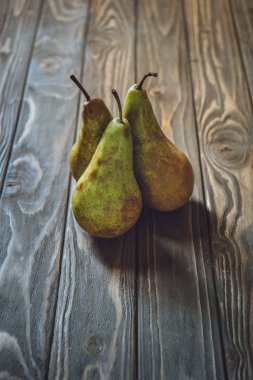 close-up shot of bunch of fresh pears on rustic wooden table clipart