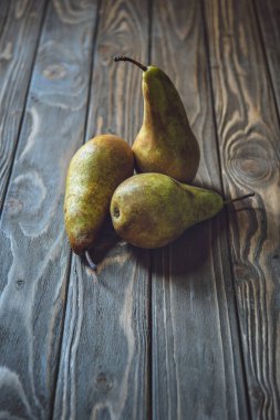 close-up shot of bunch of ripe pears on rustic wooden table clipart