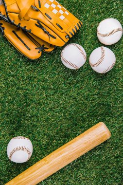 flat lay with baseball equipment arranged on green grass clipart