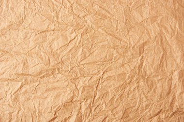 full frame of beige crumpled paper as background clipart