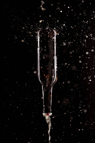 Beer Splashes Bottle Upside Falling Isolated Black Background — Stock Photo, Image