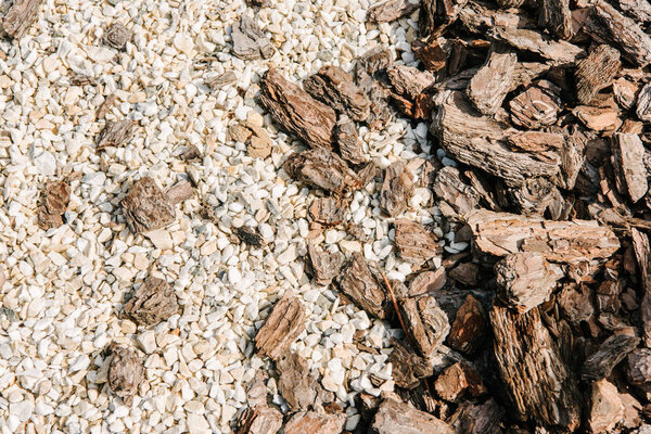 pieces of wooden bark and white pebbles for background