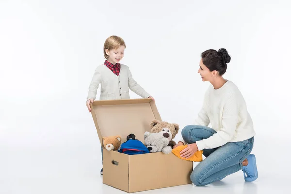 Happy Mother Son Sitting Cardboard Box Toys Isolated White — Free Stock Photo