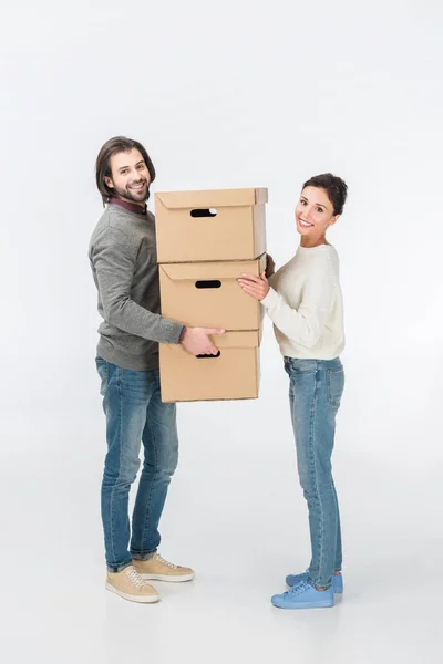 Couple Holding Stack Cardboard Boxes Looking Camera Isolated White — Stock Photo, Image