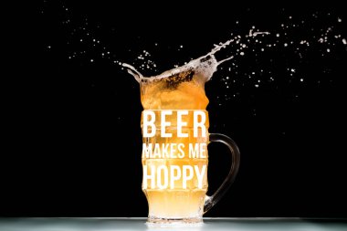 mug of light  beer with foam and splashes at table on black background with 