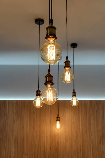 close-up view of illuminated light bulbs hanging in empty room