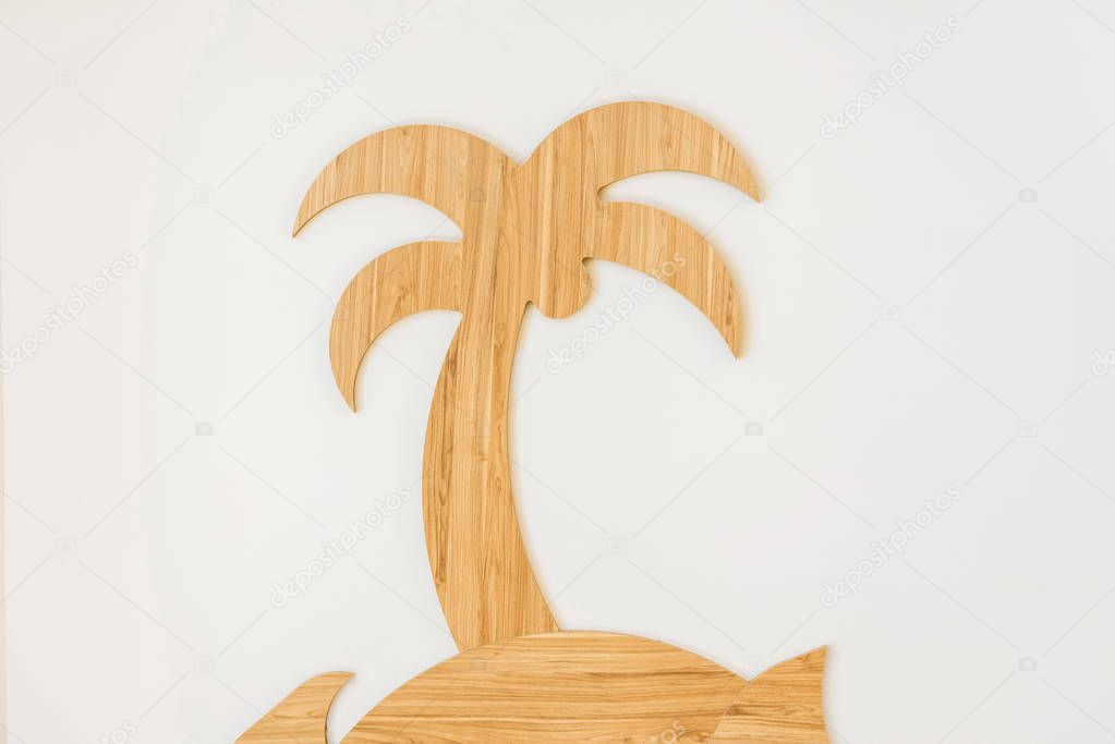 close-up view of decorative handmade wooden palm tree isolated on white