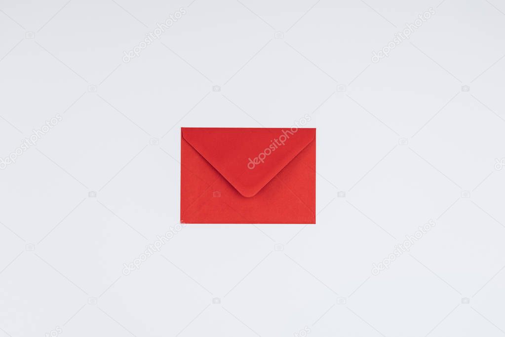 close-up view of closed single red envelope isolated on white background