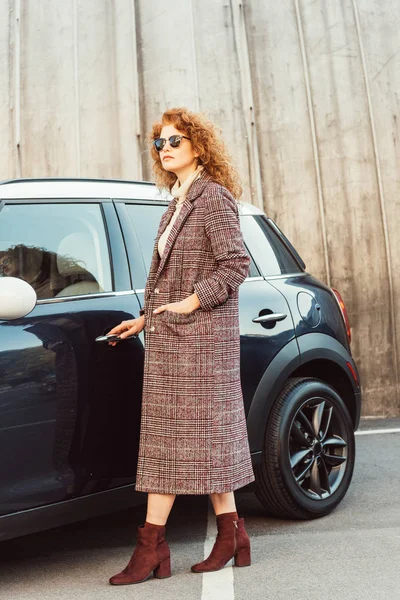 Fashionable Curly Ginger Woman Coat Sunglasses Opening Automobile Door City — Stock Photo, Image