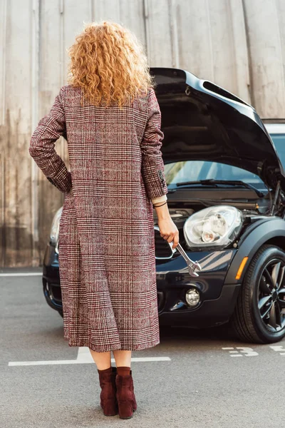 Back View Stylish Ginger Woman Coat Holding Wrench Car City — Stock Photo, Image