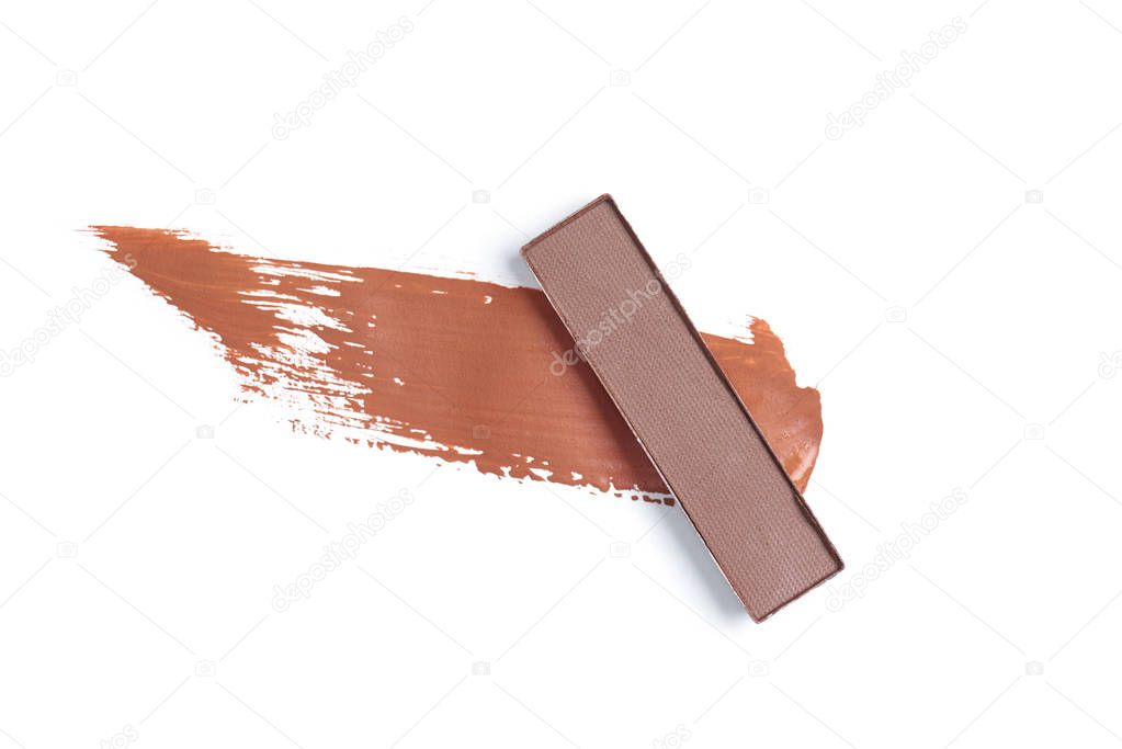 top view of eyeshadow of brown color with stroke on white background