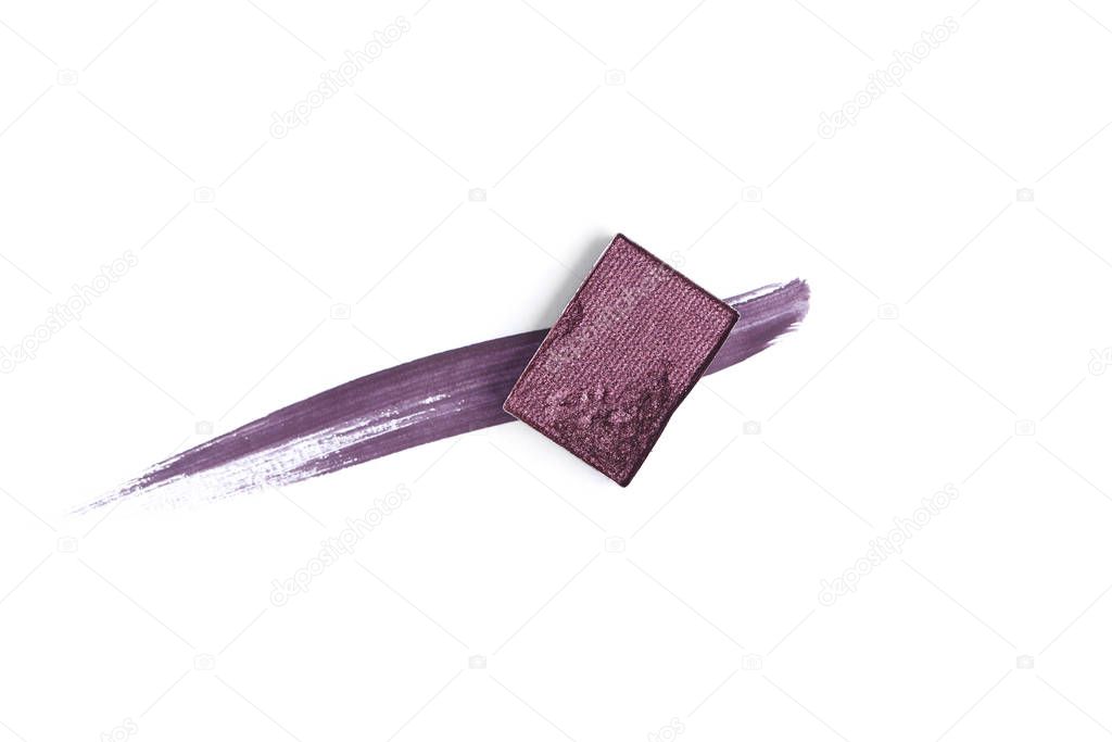 top view of eyeshadow of purple color with stroke on white background