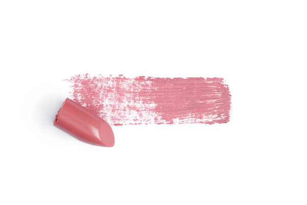 top view of pink lipstick stroke on white backdrop