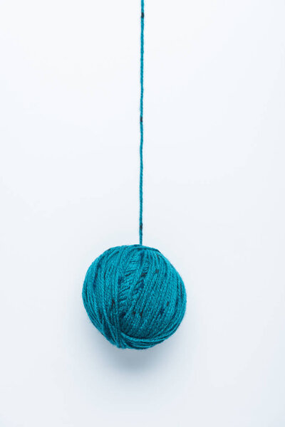 top view of blue yarn ball for knitiing on white backdrop