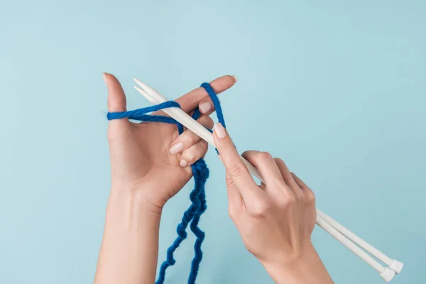 青い糸と青い背景に編み物白のニット針女の部分的なビュー — ストック写真