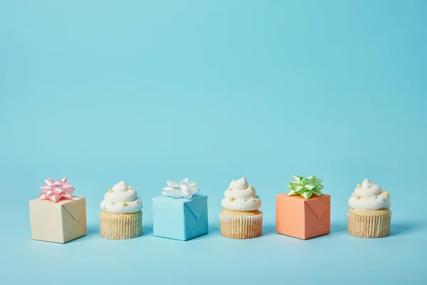 Deliciosos Cupcakes Presentes Diferentes Fundo Azul — Fotografia de Stock