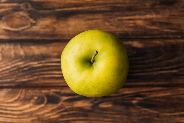 top view of ripe golden delicious apple on wooden table