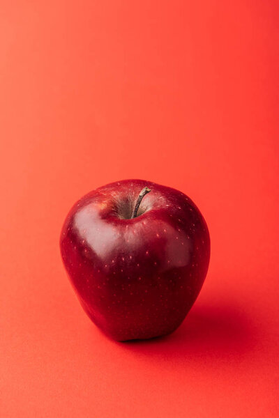 delicious large apple on red background