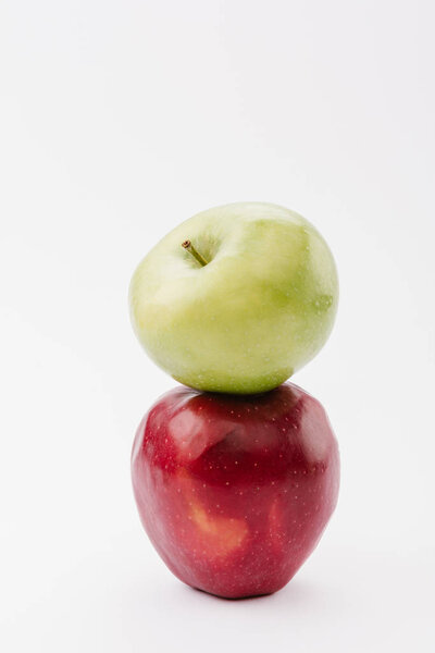 stack of two ripe red and green apples on white background