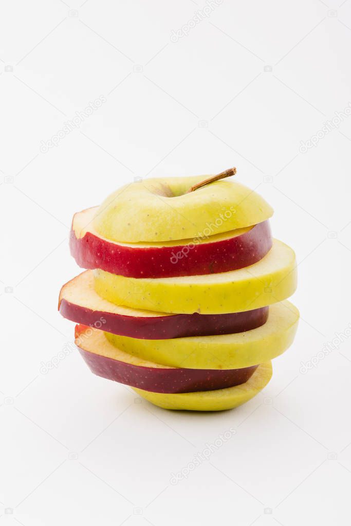 fresh sliced red and golden delicious apples on white background