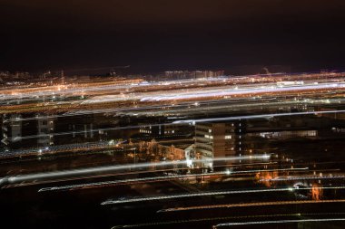 long exposure of cityscape with blurred lights at night clipart