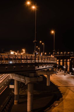 illuminated bridge and road with bright lights at night clipart