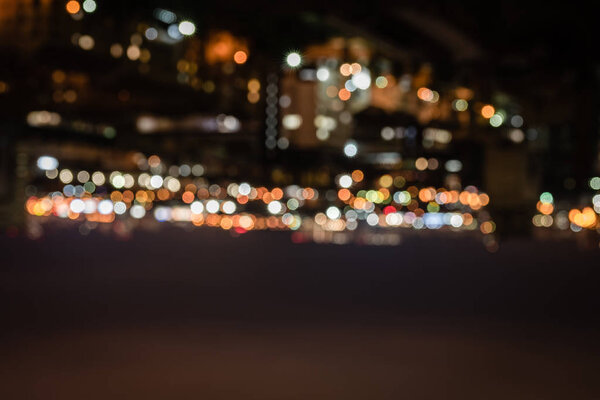 blurred buildings with bright bokeh lights at night 